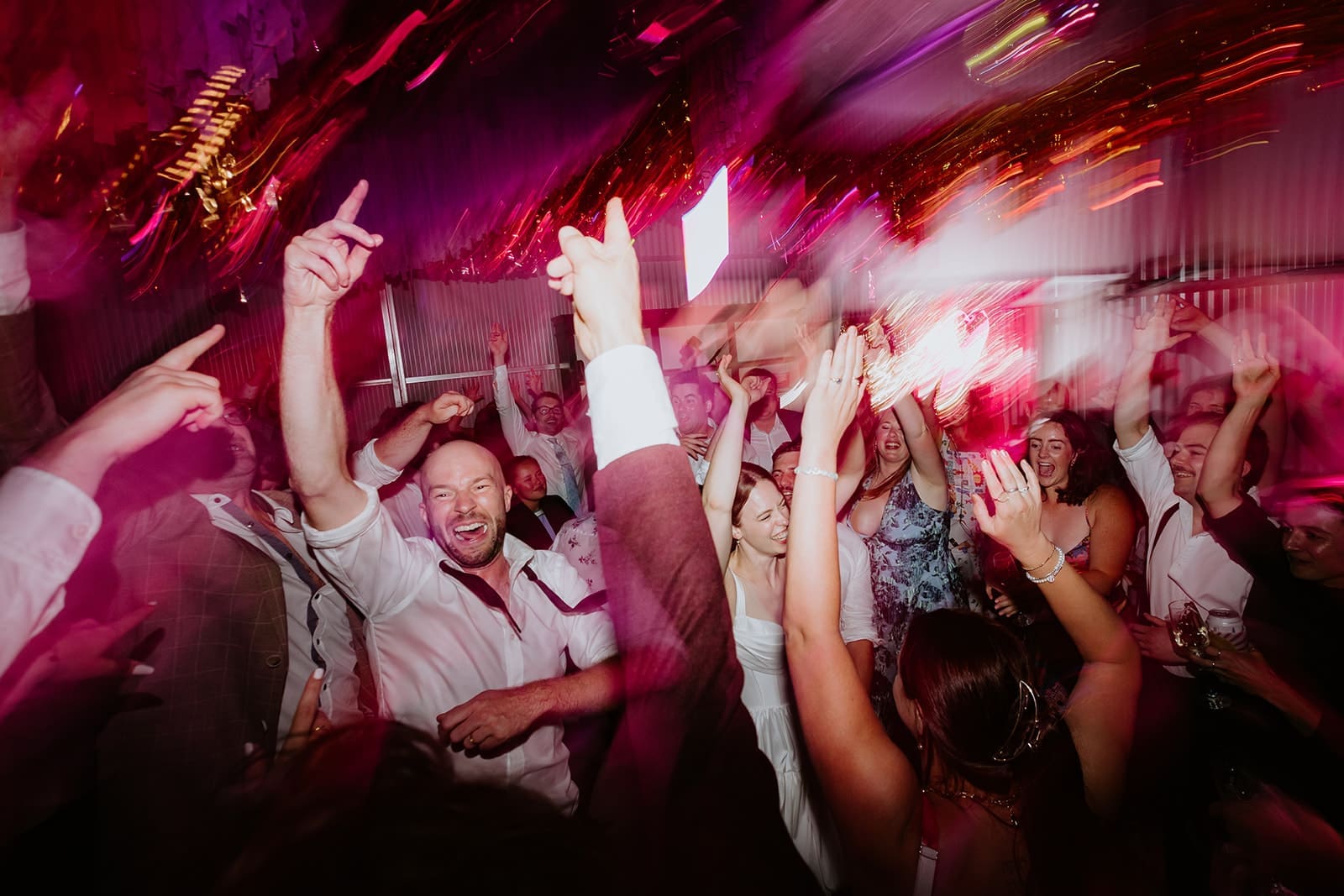 Wedding Party With Groom Throwing His Hands In The Air